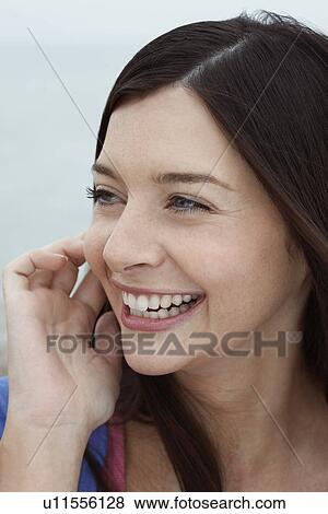 Young woman smiling close up View Large Photo Image Stock Photo - Young woman smiling close up. Fotosearch