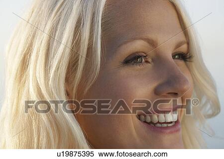 Young woman smiling close up View Large Photo Image Stock Photography - Young woman smiling close up. Fotosearch