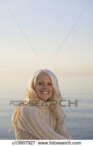 Stock Photo - Young woman smiling on beach portrait. Fotosearch