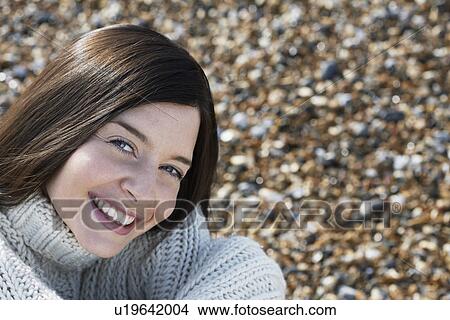 Young woman smiling sitting on beach close-up View Large Photo Image Picture - Young woman smiling sitting on beach close-up. Fotosearch