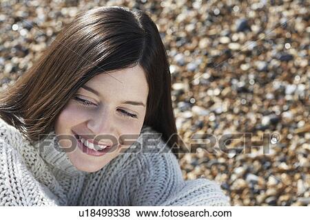 Young woman smiling sitting on beach close-up View Large Photo Image Stock Photo - Young woman smiling sitting on beach close-up. Fotosearch