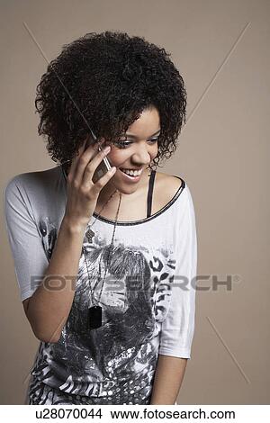 Young woman talking on mobile phone View Large Photo Image Picture - Young woman talking on mobile phone. Fotosearch