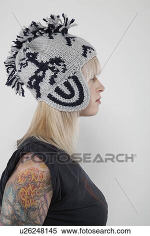 Stock Photography - Young woman wearing wool cap profile. Fotosearch