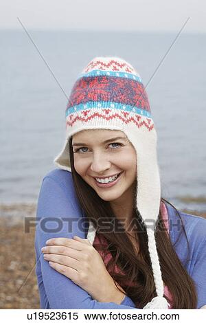 Stock Photography - Young woman wearing wool hat on beach portrait. Fotosearch
