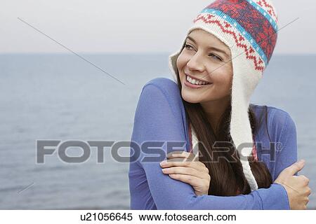 Stock Photography - Young woman wearing wool hat on beach portrait. Fotosearch