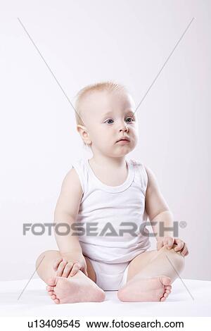 Baby boy (1-2) sitting on floor studio shot View Large Photo Image Stock Photography - Baby boy (1-2) sitting on floor studio shot. Fotosearch