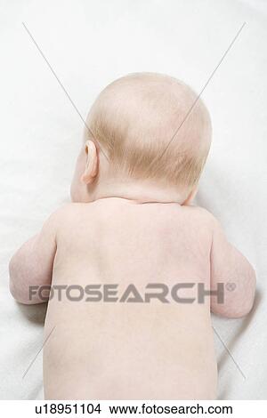 Picture - Baby boy lying down. Fotosearch