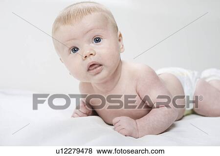 Stock Photo - Baby boy lying down. Fotosearch