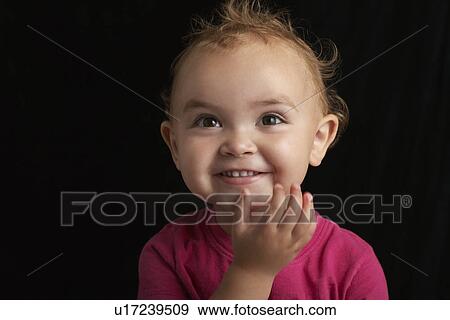 Baby girl (1-2) on black background close-up View Large Photo Image Stock Photo - Baby girl (1-2) on black background close-up. Fotosearch
