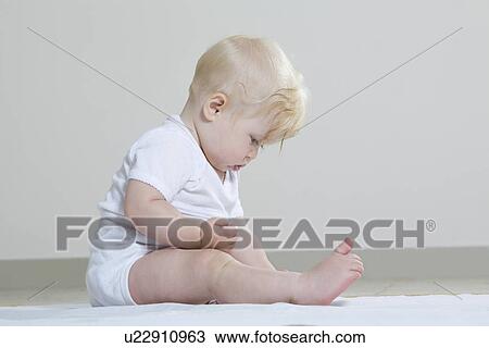 Baby girl playing on floor View Large Photo Image Stock Image - Baby girl playing on floor. Fotosearch