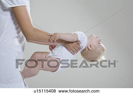 Baby girl resting in mother's hands View Large Photo Image Stock Photo - Baby girl resting in mother's hands. Fotosearch