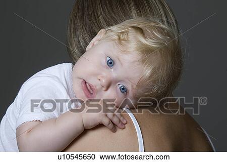 Baby girl resting on mother's arm View Large Photo Image Stock Image - Baby girl resting on mother's arm. Fotosearch