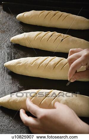 Stock Photo - Baker Preparing Bread Dough To Bake. Fotosearch