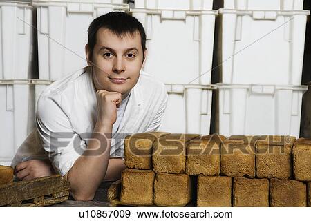 Baker With Loaves of Fresh Bread View Large Photo Image Stock Photo - Baker With Loaves of Fresh Bread. Fotosearch