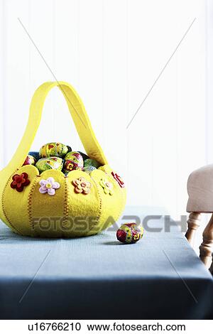 Stock Image - Basket with Easter eggs. Fotosearch