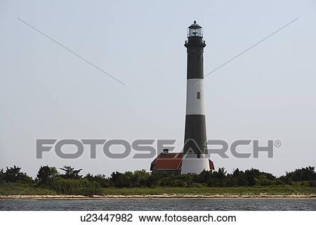 Stock Image - Beach and lighthouse. Fotosearch