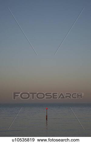 Beacon in ocean at dusk View Large Photo Image Stock Photo - Beacon in ocean at dusk. Fotosearch