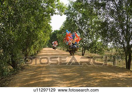 Bicycles with Festive Decorations on a Dirt Road View Large Photo Image Stock Photo - Bicycles with Festive Decorations on a Dirt Road. Fotosearch
