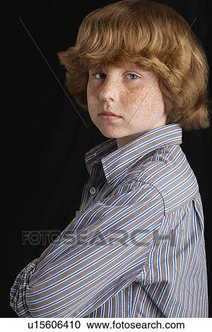 Boy (10-12) on black background portrait View Large Photo Image Stock Image - Boy (10-12) on black background portrait. Fotosearch