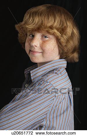 Boy (10-12) on black background portrait View Large Photo Image Stock Image - Boy (10-12) on black background portrait. Fotosearch