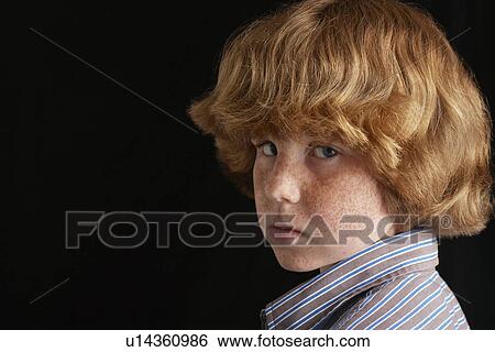Boy (10-12) on black background portrait close-up View Large Photo Image Stock Photograph - Boy (10-12) on black background portrait close-up. Fotosearch