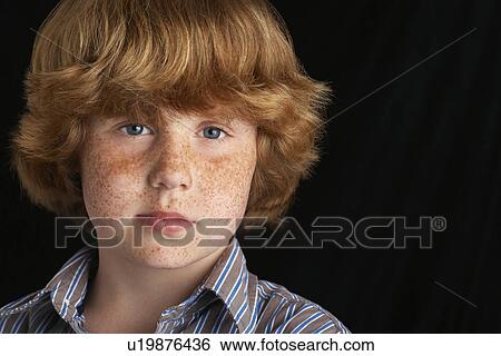 Boy (10-12) on black background portrait close-up View Large Photo Image Stock Photograph - Boy (10-12) on black background portrait close-up. Fotosearch
