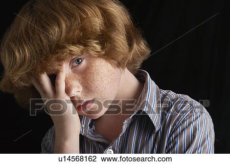 Boy (10-12) with hand on chin black background portrait close-up View Large Photo Image Stock Image - Boy (10-12) with hand on chin black background portrait close-up. Fotosearch