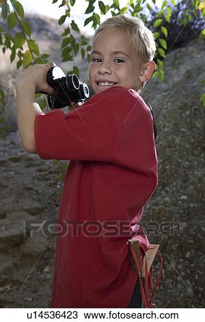 Boy (7-9) using binoculars View Large Photo Image Stock Image - Boy (7-9) using binoculars. Fotosearch