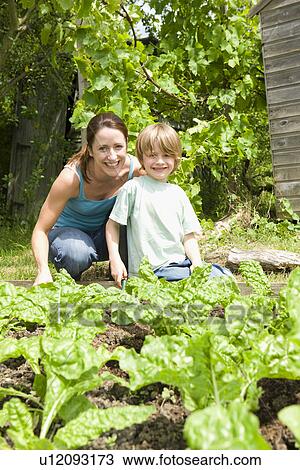 Boy gardening with mother portrait View Large Photo Image Stock Image - Boy gardening with mother portrait. Fotosearch