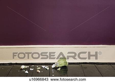 Stock Image - Broken figurine on floor. Fotosearch