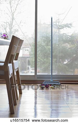 Picture - Broom and small pile of broken Christmas decorations. Fotosearch