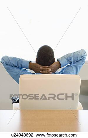 Stock Image - Businessman with Hands behing Head Rear View. Fotosearch