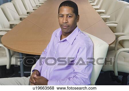 Stock Photo - Businesswoman Sitting at Meeting Table Portrait. Fotosearch