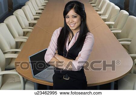 Stock Photography - Businesswoman Standing in Meeting Room High Angle. Fotosearch