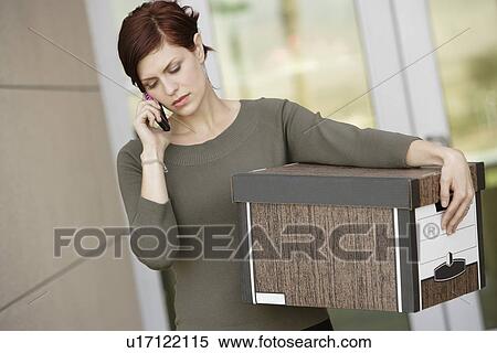 Stock Photography - Businesswoman Using Mobile Phone with Moving Box. Fotosearch
