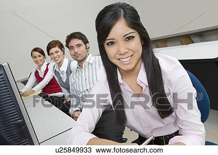 Cheerful Multi Racial Group of Business people Sitting at Desk View Large Photo Image Stock Image - Cheerful Multi Racial Group of Business people Sitting at Desk. Fotosearch