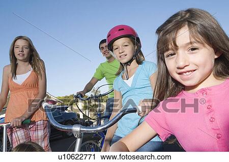 Stock Image - Children with scooters and bicycle. Fotosearch