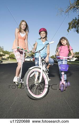 Stock Photo - Children with scooters and bicycle. Fotosearch