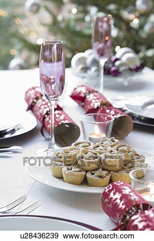 Christmas crackers and mince pies on dining table View Large Photo Image Stock Photo - Christmas crackers and mince pies on dining table. Fotosearch