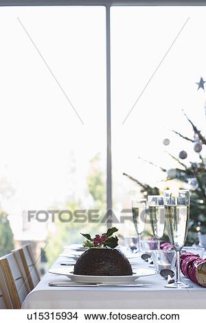 Christmas table with champagne and pudding View Large Photo Image Picture - Christmas table with champagne and pudding. Fotosearch