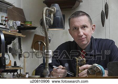 Stock Photograph - Clock Repairman at Work. Fotosearch