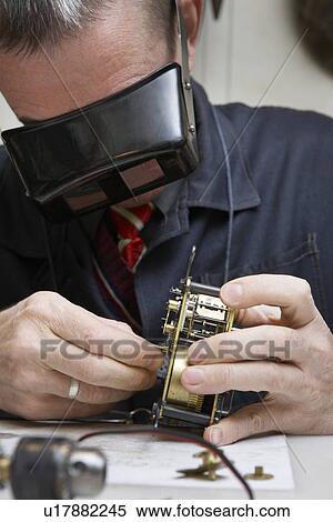 Clock Repairman at Work View Large Photo Image Stock Photography - Clock Repairman at Work. Fotosearch