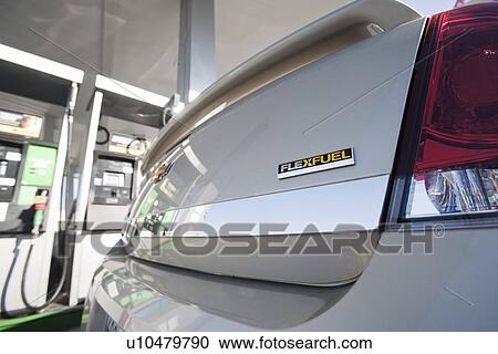 Stock Image - Close up of flexible fueled car at gas station. Fotosearch