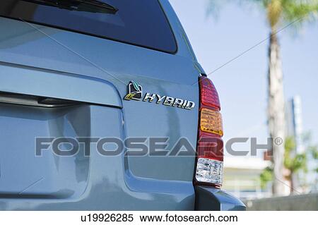 Stock Photography - Close up of sing on hybrid car. Fotosearch