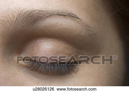Close-up of young woman's closed eye View Large Photo Image Stock Photograph - Close-up of young woman's closed eye. Fotosearch