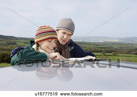 Stock Photo - Couple Consulting a Map. Fotosearch