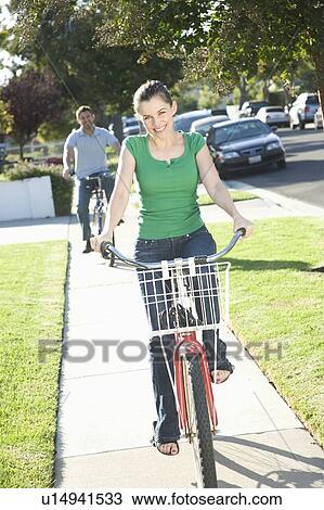 Stock Image - Couple riding bicycles. Fotosearch