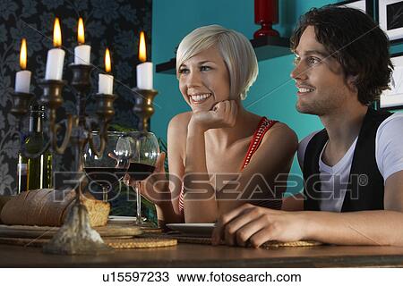 Couple sitting at dining table close up View Large Photo Image Stock Image - Couple sitting at dining table close up. Fotosearch