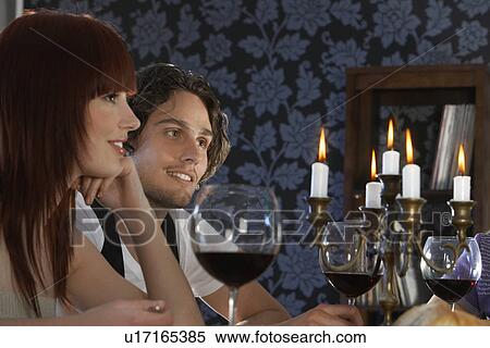 Couple sitting at dining table close up View Large Photo Image Stock Photography - Couple sitting at dining table close up. Fotosearch