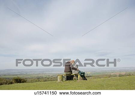 Couple Sitting on a Park Bench View Large Photo Image Stock Image - Couple Sitting on a Park Bench. Fotosearch
